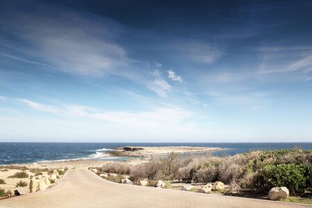 road way leading doen to the aerial training aid for WWII in Qawra Point Beach in maltaの写真素材