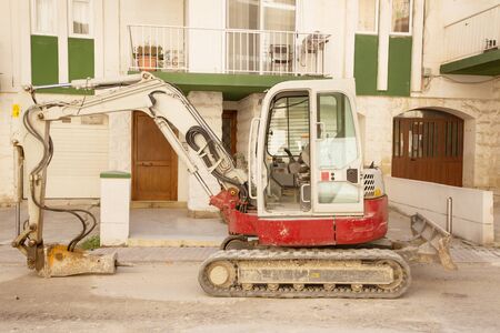 small digger with a hammer drill in place of a bucket