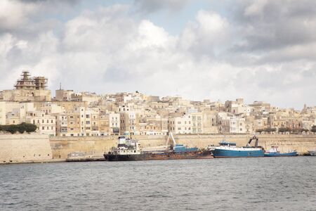 boats on the water outside valletta the capital city of maltaの写真素材