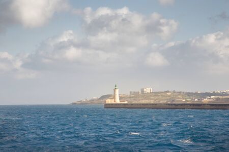 seascape image of the lighthouse at the end of the pier in Valletta malta の写真素材