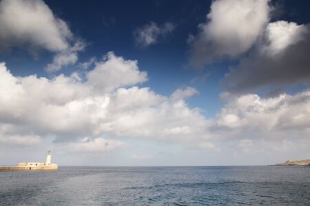 seascape image of the lighthouse at the end of the pier in Valletta malta の写真素材
