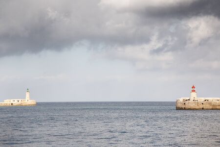 the two light house of the grand harbour malta  looking out to seaの写真素材