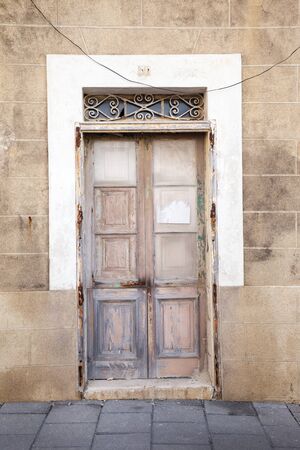 old wooden front of a door on a building in maltaの写真素材