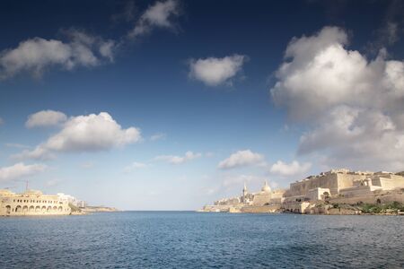 seascape of Manoel Island with the aches of the Lazzaretto the old  quarantine facility and hospital on one side and the town of valletta the capital city of malta on the otherの写真素材