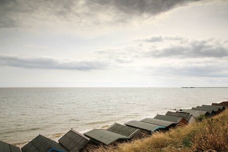beach huts along the seafront in walton on the naze essex england