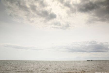 seascape image looking out to sea on a calm and cloudy day in englandの写真素材
