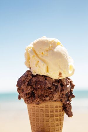 ice cream cone against a blue sky sea and the seaside beachの写真素材