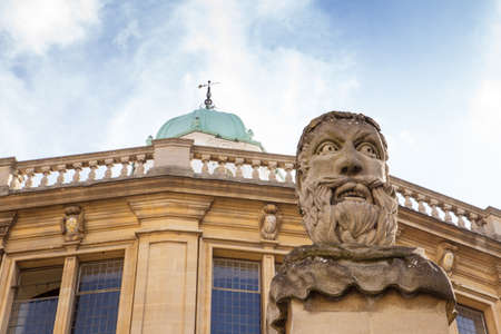 There are thirteen square pillars topped by head-and-shoulder busts marking the front boundary of the sheldonian theatre in oxfordのeditorial素材