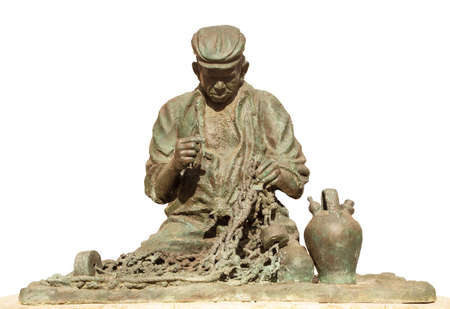 cut out on white of Statue of a old fisherman fixing his net Fuengirolaのeditorial素材