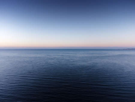 sunrise with the sun coming up over the sea in Costa del Sol spainの写真素材