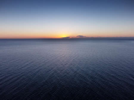 sunrise with the sun coming up over the sea in Costa del Sol spainの写真素材