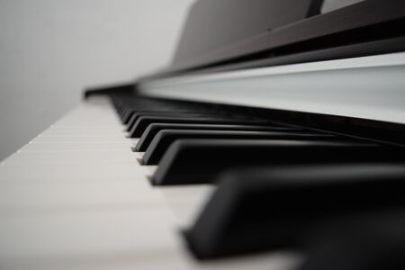 Piano keyboard with a white background. Classical music playing. Close up of keys.の写真素材