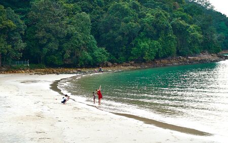 Langkawi, Malaysia - October 12, 2019. Mother and daughter posing for picture at Pasir Tengkorak Beach.のeditorial素材