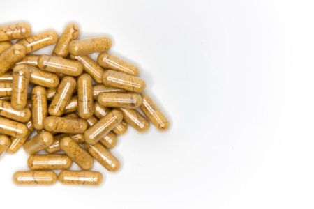 heap capsules of capsules on white background.の写真素材