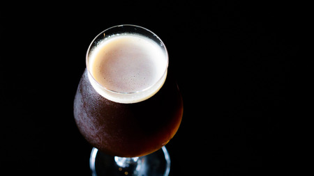 Belgian dubbel beer , dubbel is a belgian  beer. Rich malty ,mild alcoholic ,dark fruit aromas, dark amber color.の写真素材