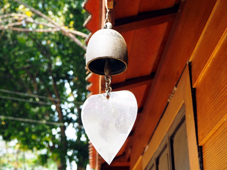 Antique Brass Bell Hanging Over the Window