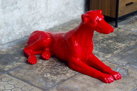 The Red Dog Statue on the Groundの写真素材