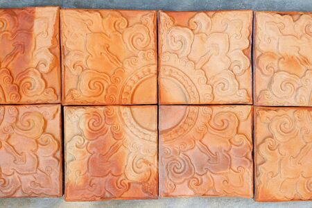 Vintage Clay Tiles Decorated on the Concrete Wallの写真素材