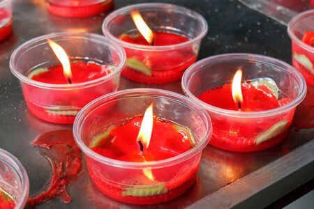 Burning Red Candle Bowls at the Chinese Templeの写真素材