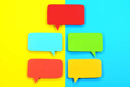 Multicolored speech bubbles on yellow blue backgroundの写真素材