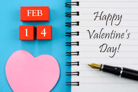 Happy Valentine's Day wishes on notebook with love hearts