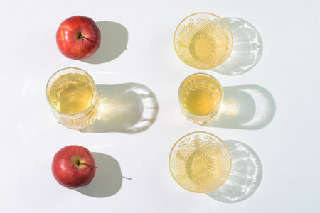 Apple cider vinegar and apples arranged on a tableの写真素材