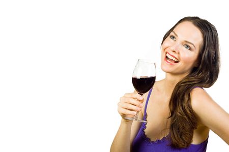 Beautiful young brunette laughing and holding a glass of red wine. Isolated over whiteの写真素材