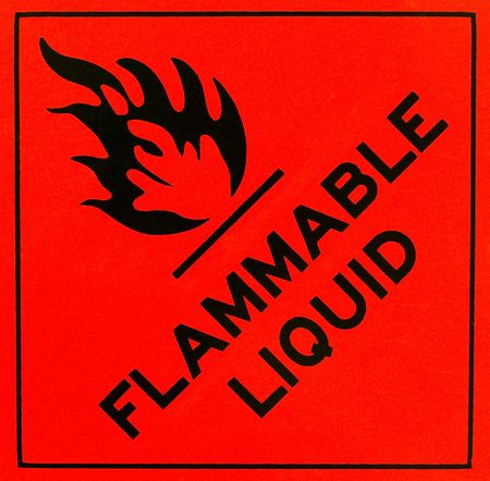 An orange flammable liquid warning sign with black writingの写真素材