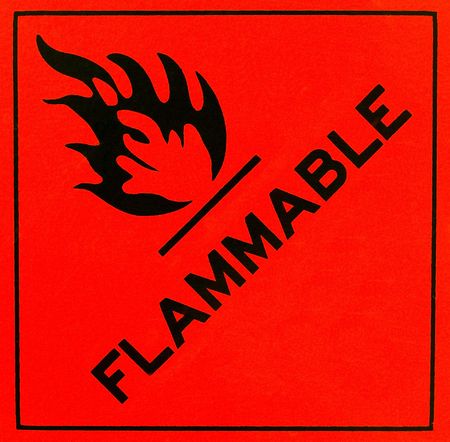 An orange flammable warning sign with black writingの写真素材
