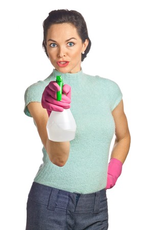 Portrait of beautiful young housewife with spray bottle. Isolated over whiteの写真素材