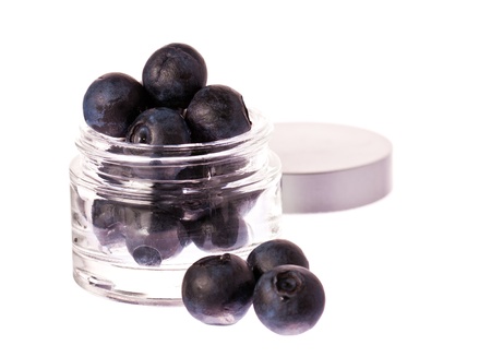 Fresh blueberries in a glass beauty cream jar の写真素材