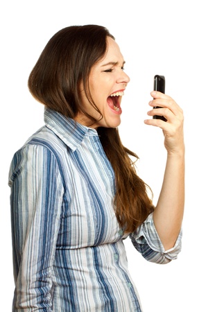 An angry and very frustrated young business woman yelling at her phone. Isolated over white.の写真素材