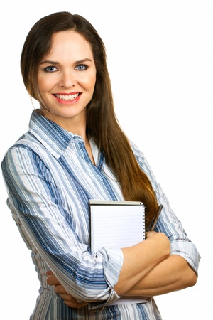 A portrait of a beautiful confident business woman smiling and holding a note pad and pen. Isolated over white.の写真素材