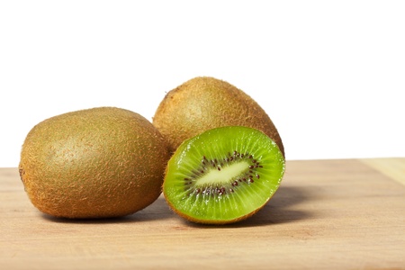 Fresh juicy colorful kiwis on a cutting boardの写真素材