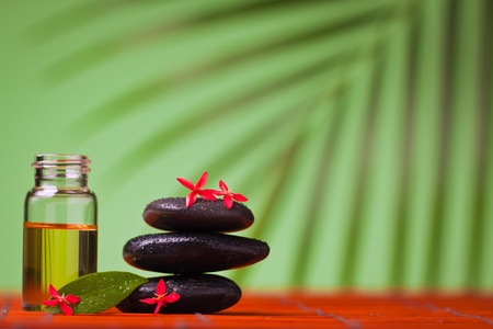 Health spa & massage still life of massage oil and balancing rocks.の写真素材