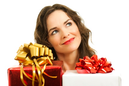 Beautiful young woman choosing christmas presents. Isolated over white.の写真素材