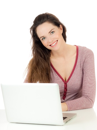 Closeup of a young cute woman using a laptop computerの写真素材