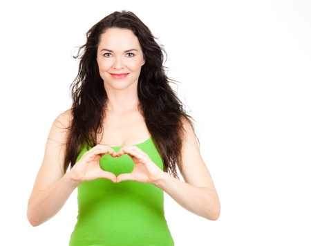 Beautiful young woman symboling a love heart with hands  Isolated over white の写真素材