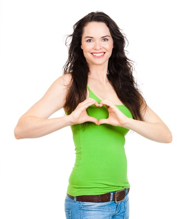 A beautiful woman symboling a love heart in front of her breast  Symbolizing womens health の写真素材