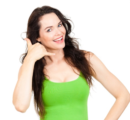 CLose-up of a  beautiful young woman smiling and making a call me sign  Isolated over white の写真素材