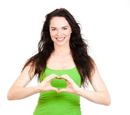 Beautiful young woman symboling a love heart with hands  Isolated over white の写真素材