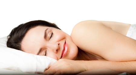 A beautiful young woman sleeping peacefully  Isolated over white の写真素材