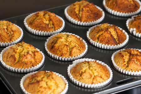 Delicious fresh home made muffins on a oven trayの写真素材