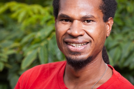 Close-up portrait of a dark skinned smiling young manの写真素材