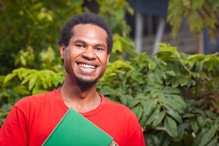 A happy dark skinned malel studentの写真素材