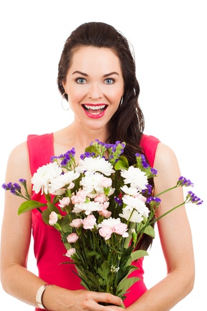 A beautiful young woman holding a bunch of flowersの写真素材