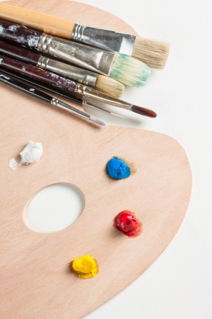 Paint brushes and paint on a palletteの写真素材