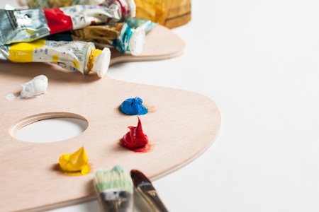 Oil paint tubes, paint brushes and paint on a palletteの写真素材