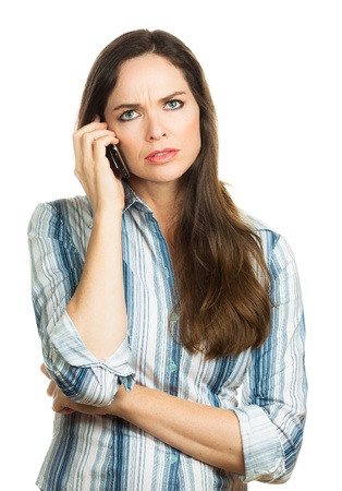 An annoyed and very disappointed business woman on the phone  Isolated over white の写真素材