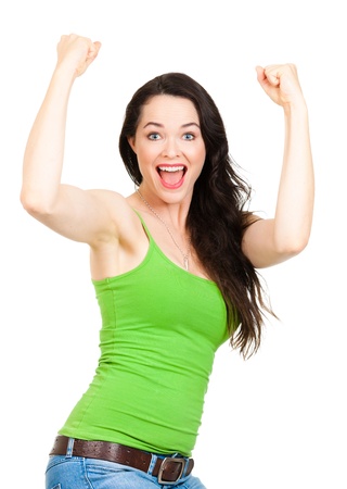 A fit young, beautiful happy woman with her arms in the air indicating success  Isolated on white の写真素材